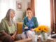 Nurse cosulting with senior her health condition.