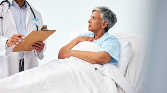 Woman in bed, doctor with medical chart and checklist for health insurance, consultation and diagno Woman in bed, doctor with medical chart and checklist for health insurance, consultation and diagno